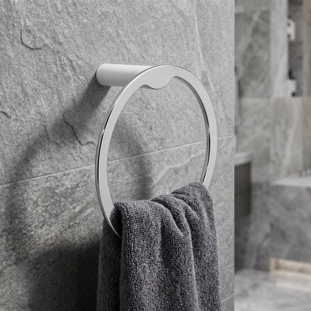 Towel rack with a towel on a stone wall in a bathroom setting