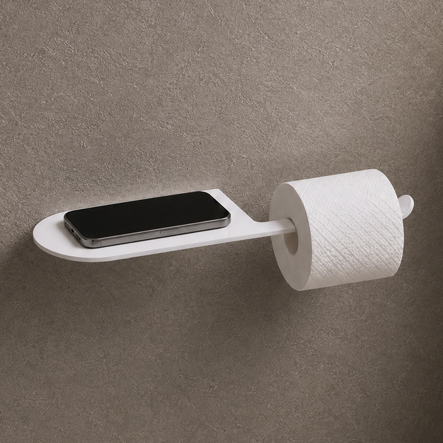Wall-mounted toilet paper holder with smartphone tray in a bathroom setting.