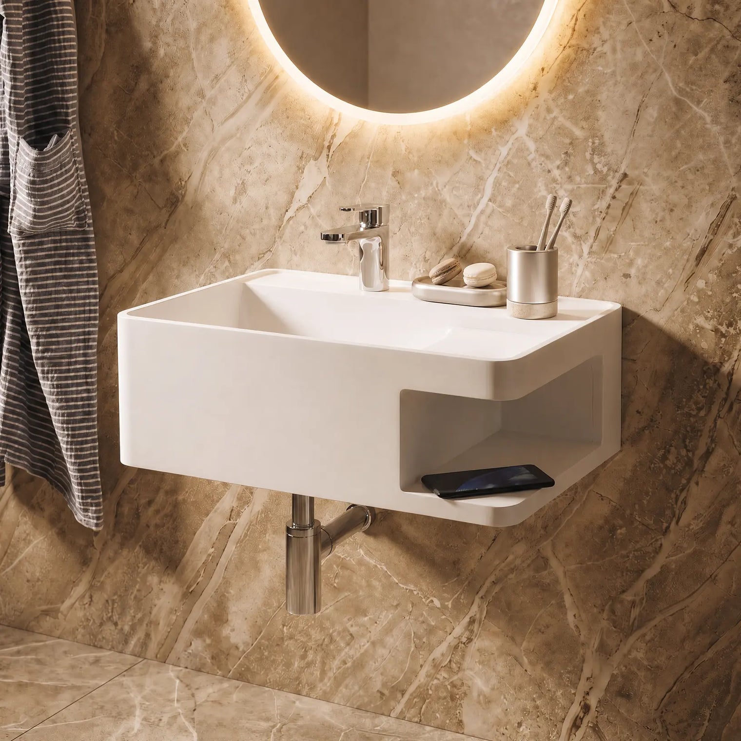 A modern white wall-mounted sink with a chrome faucet and side shelf, installed in a brown marble bathroom with a lit round mirror and a striped towel hanging on the left.
