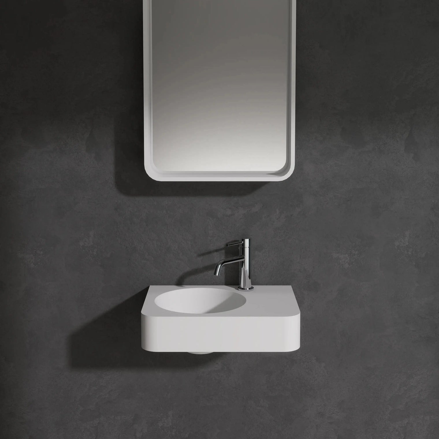 Bathroom setup with a mirror and sink against a dark wall