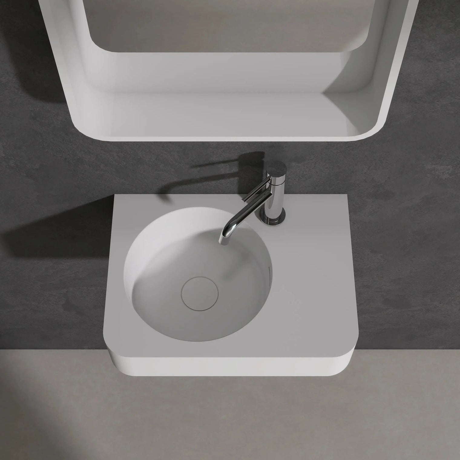 Modern bathroom sink with mirror above on a dark gray wall.