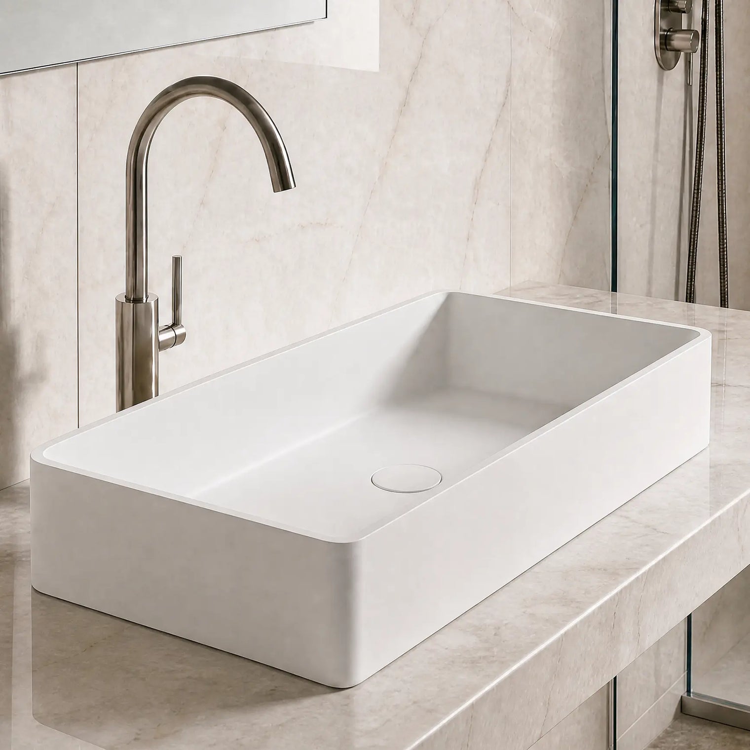 Modern bathroom with a white sink and bronze faucet against a marble wall.