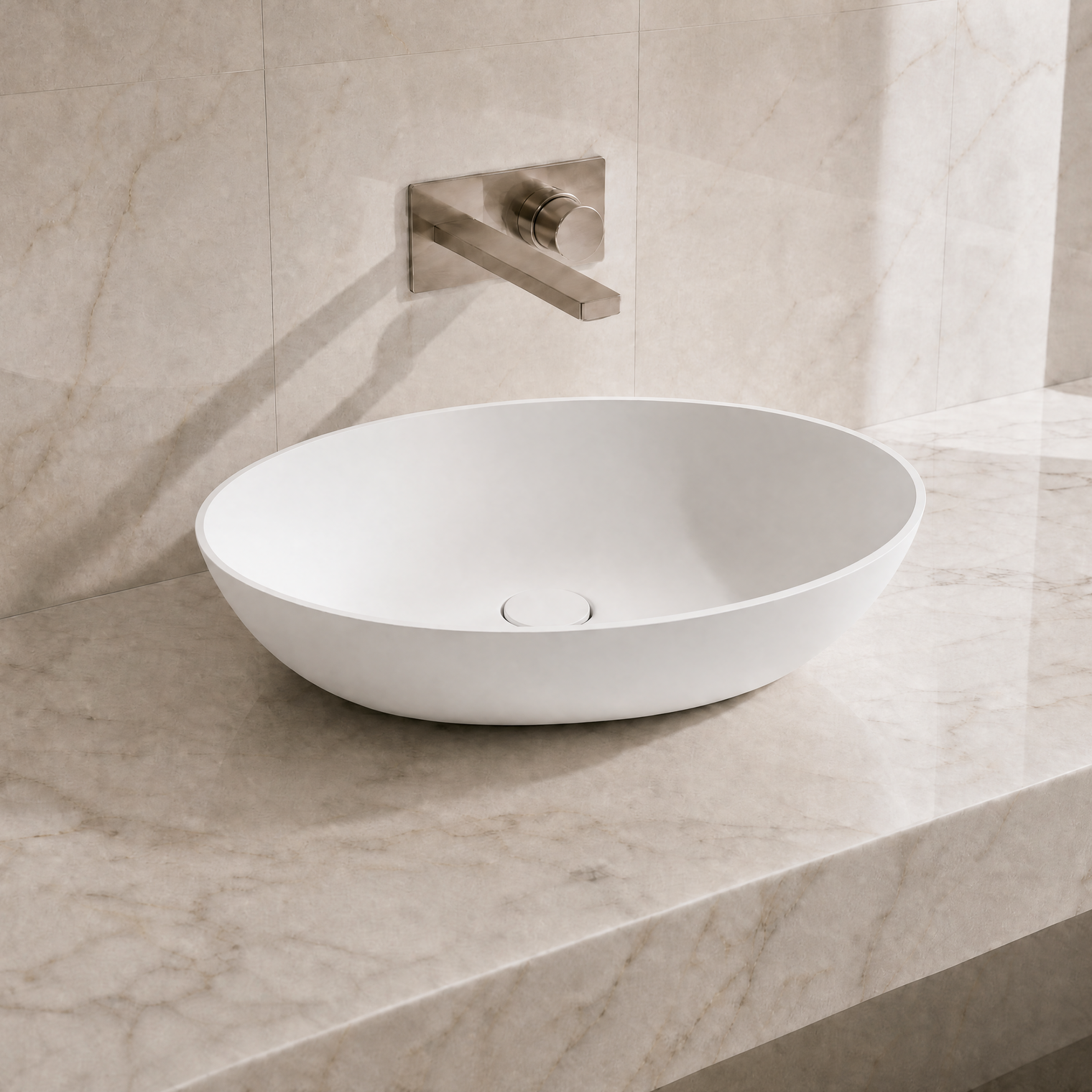 White ceramic sink on a marble countertop with a matching wall-mounted faucet.