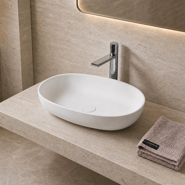 Bathroom Solid Surfaces sink with faucet and towel on a beige countertop