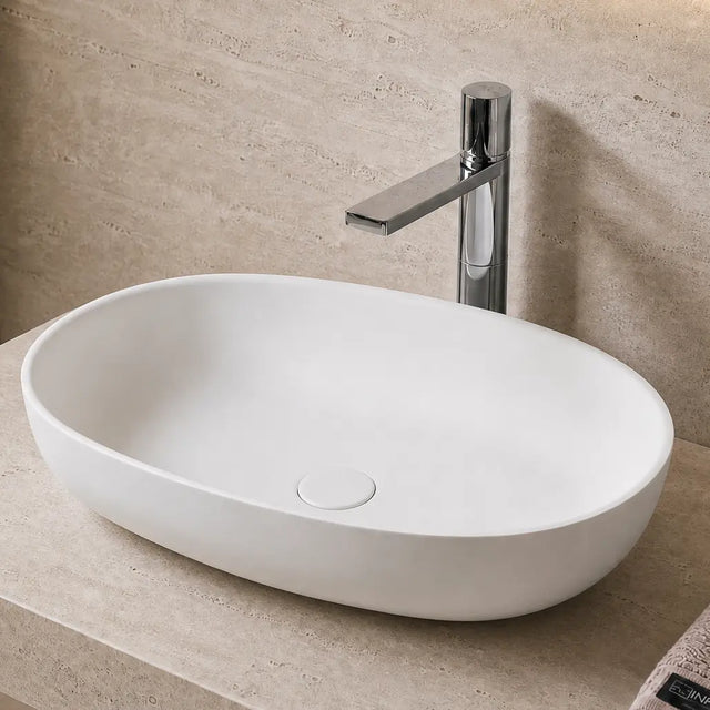 Bathroom Solid Surfaces sink with faucet and towel on a beige countertop