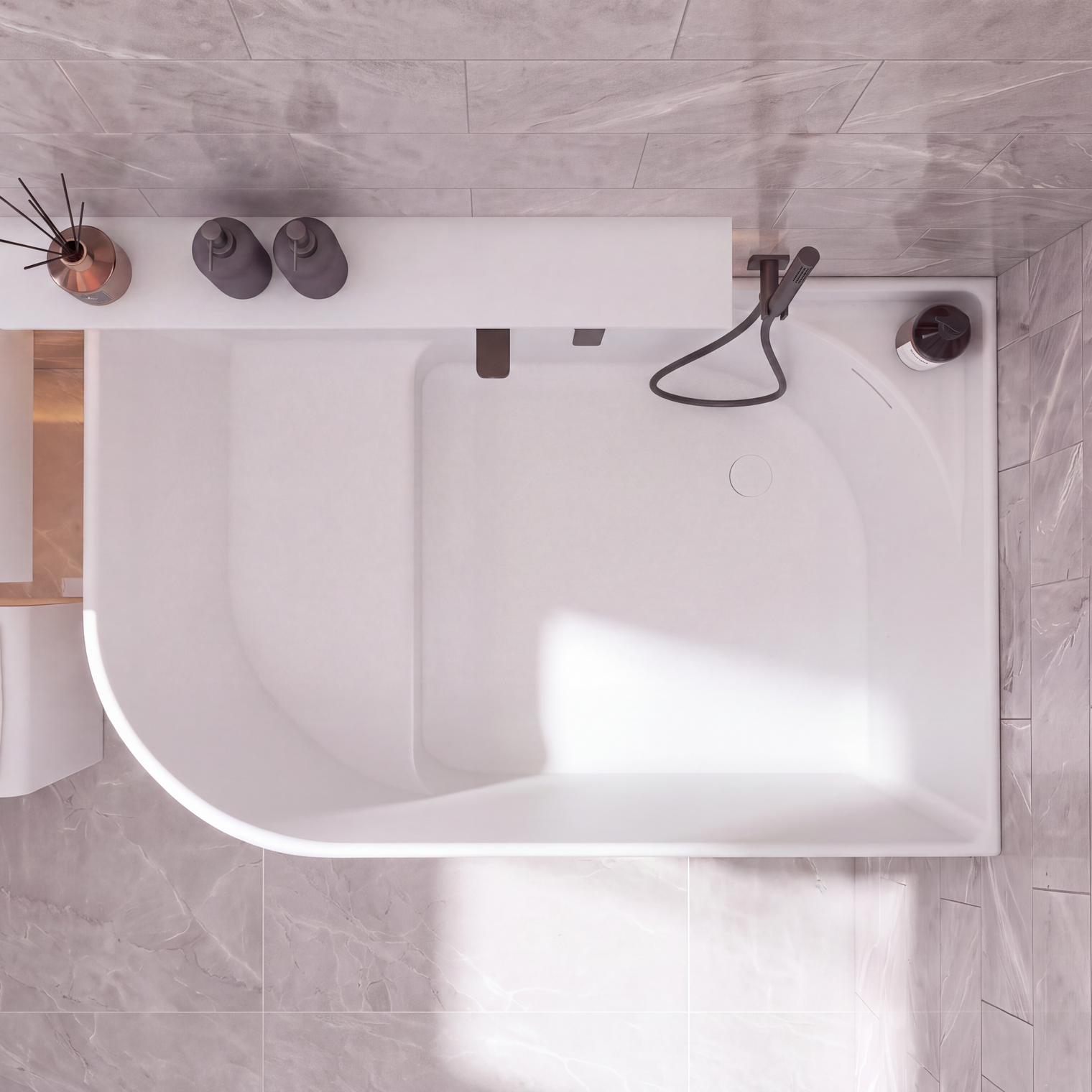 A modern white freestanding bathtub with a matte black handheld shower and faucet, shown from a top-down view in a tiled bathroom with gray stone-look tiles.