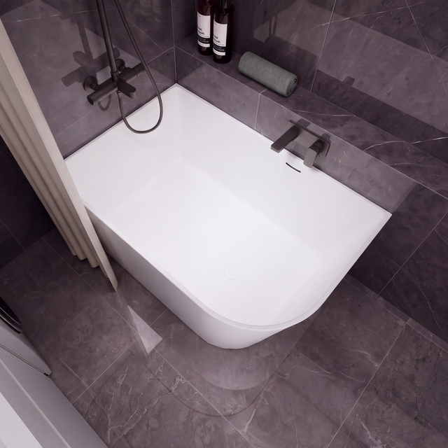 A modern white freestanding bathtub with a dark gray tiled bathroom setting, featuring a wall-mounted chrome faucet, a handheld shower attachment, and a beige curtain on the left.