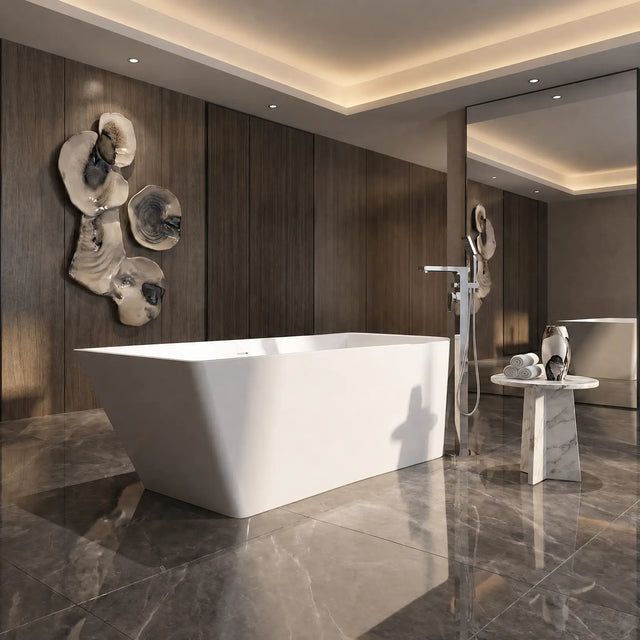 A modern freestanding white bathtub in a luxurious bathroom with dark wood paneling, gray marble flooring, a wall-mounted chrome shower head, and decorative wall art.