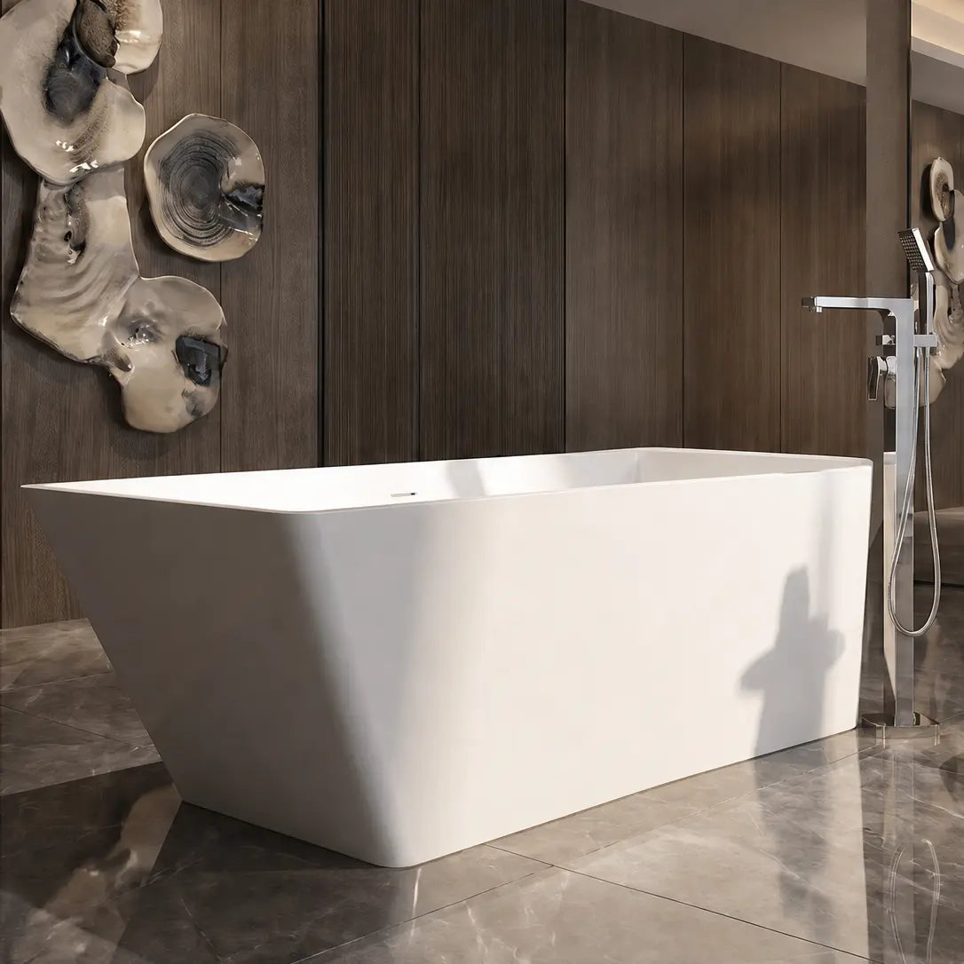 A modern freestanding white bathtub in a luxurious bathroom with dark wood paneling, gray marble flooring, a wall-mounted chrome shower head, and decorative wall art.