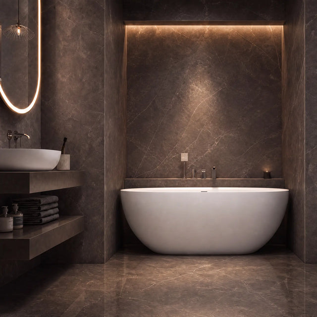 A modern freestanding oval bathtub in a luxurious bathroom with dark brown marble walls and floor, warm ambient lighting, and a floating vanity on the left.