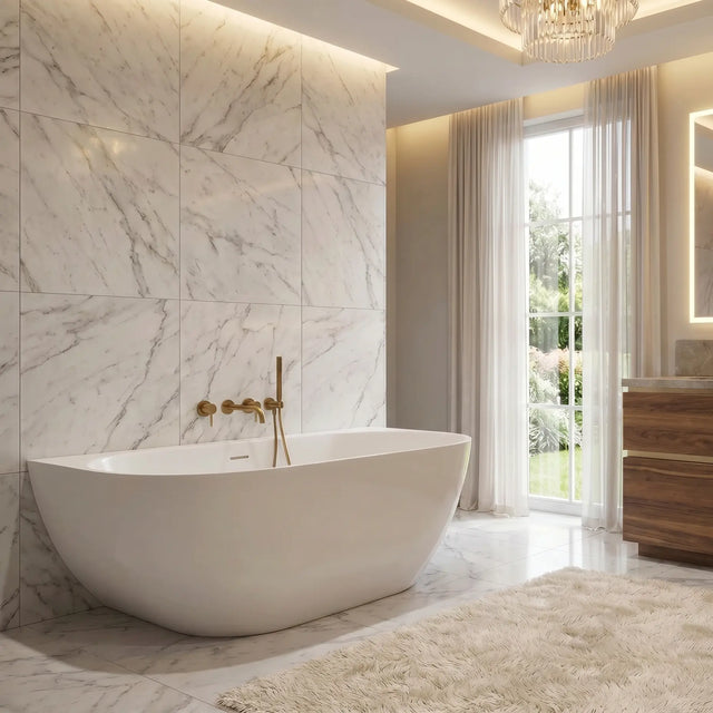 A luxury modern bathroom featuring a white freestanding bathtub set against a large white marble tiled wall, with a wooden vanity, illuminated mirror, and a soft beige rug on the floor.