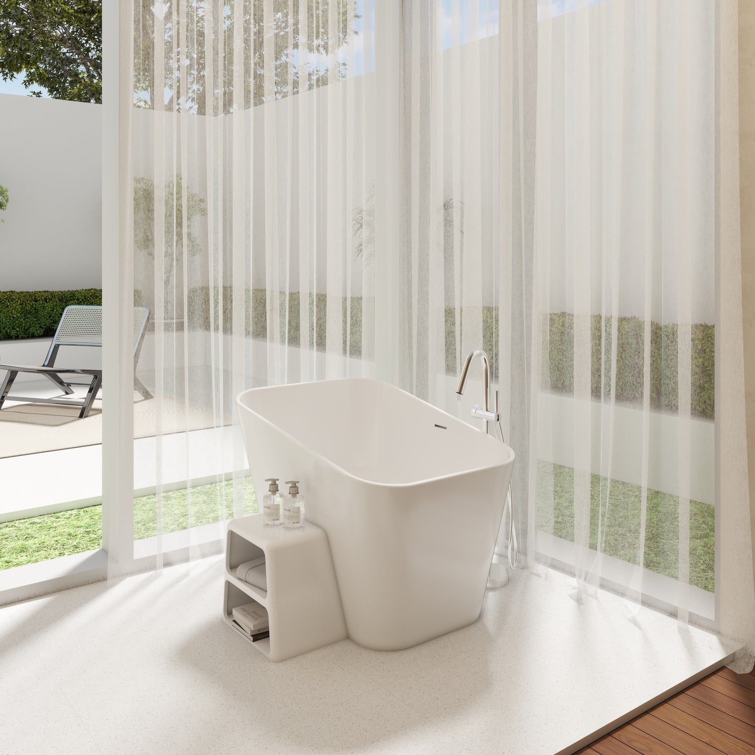 A modern freestanding white bathtub placed in a bright, minimalist bathroom with sheer white curtains, large floor-to-ceiling windows, and an outdoor patio visible beyond.