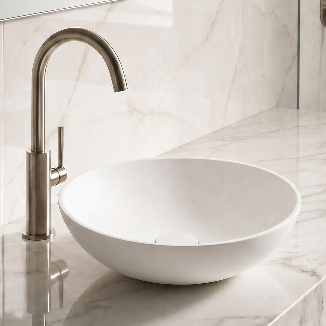 Bathroom sink with marble countertop and tiled wall