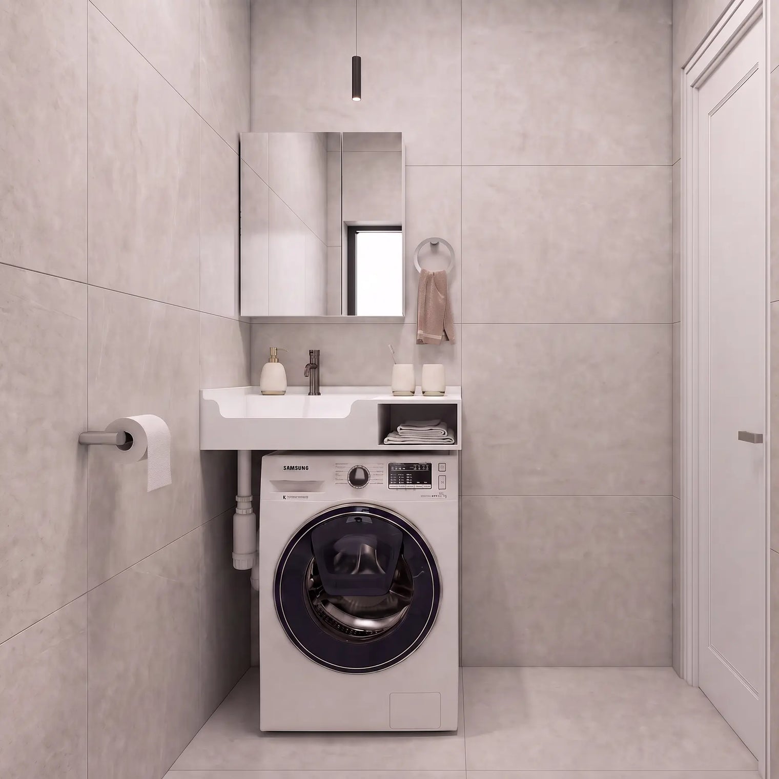 A compact bathroom setup featuring a white front-loading washing machine integrated beneath a matching white sink and mirror, set against light gray tiled walls and floor.