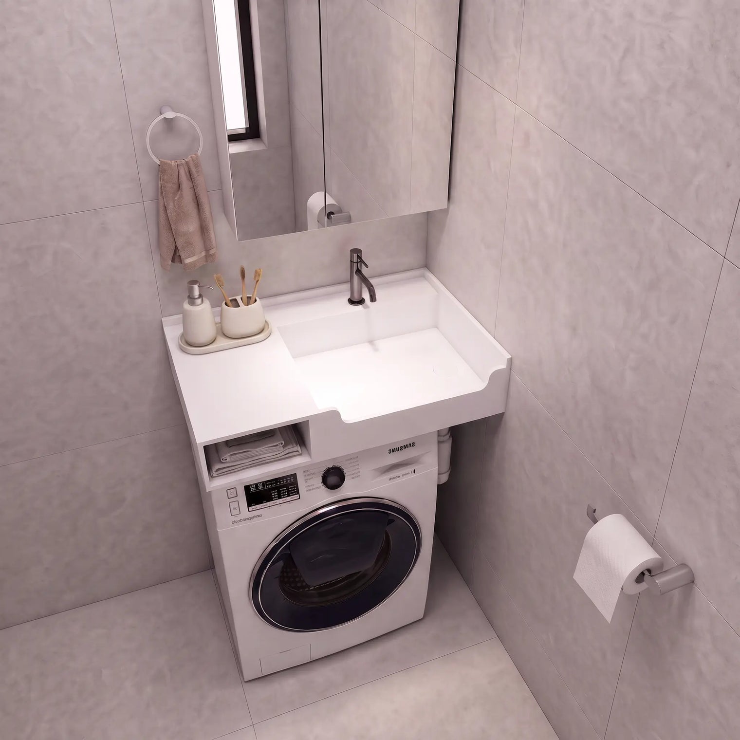 A compact bathroom vanity setup with a white sink and countertop, integrated washing machine underneath, shown in a tiled bathroom. A mirror, faucet, soap dispenser, and toilet paper holder are visible.