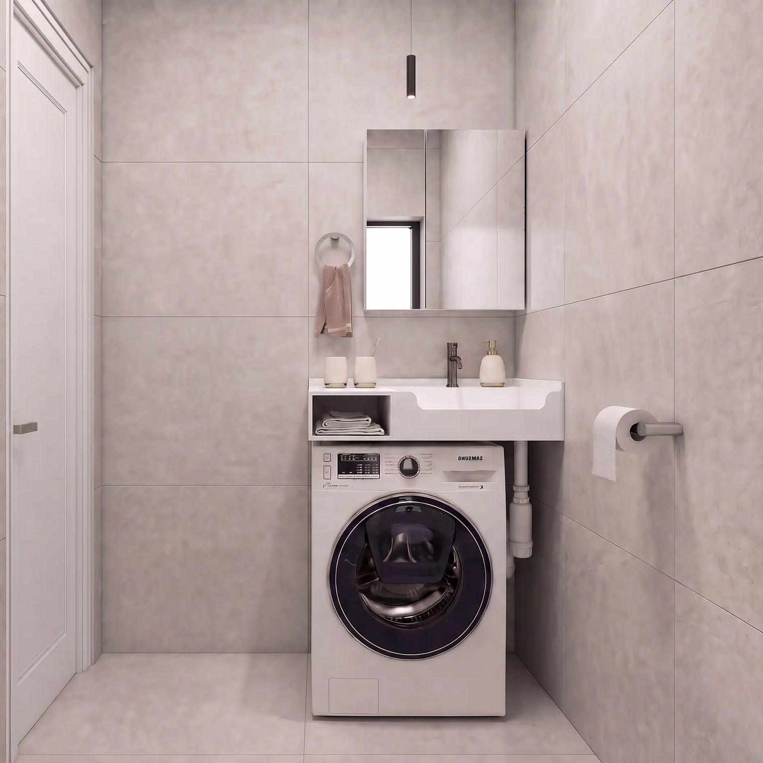 A compact bathroom setup featuring a white front-loading washing machine integrated beneath a matching white sink and mirror, set against light gray tiled walls and floor.