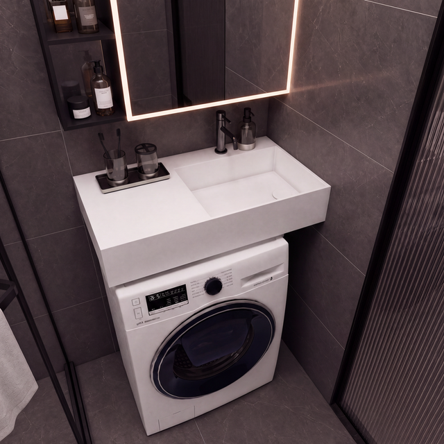 A modern bathroom vanity setup with a white integrated sink and washing machine cabinet, set against dark gray tiled walls under a lit mirror.