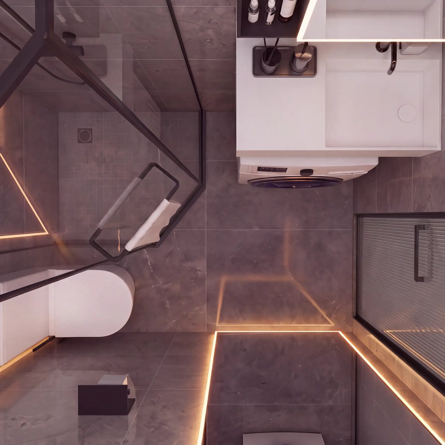 Modern bathroom interior with gray stone-look tiles, warm LED strip lighting, a white toilet, a white vanity unit, and a glass shower screen with black framing.