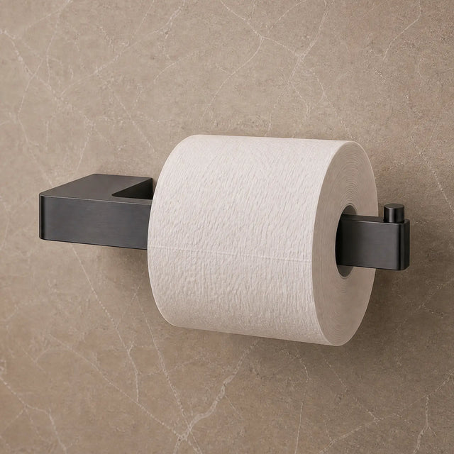 Black toilet paper holder with a roll of toilet paper on a beige tiled bathroom wall.