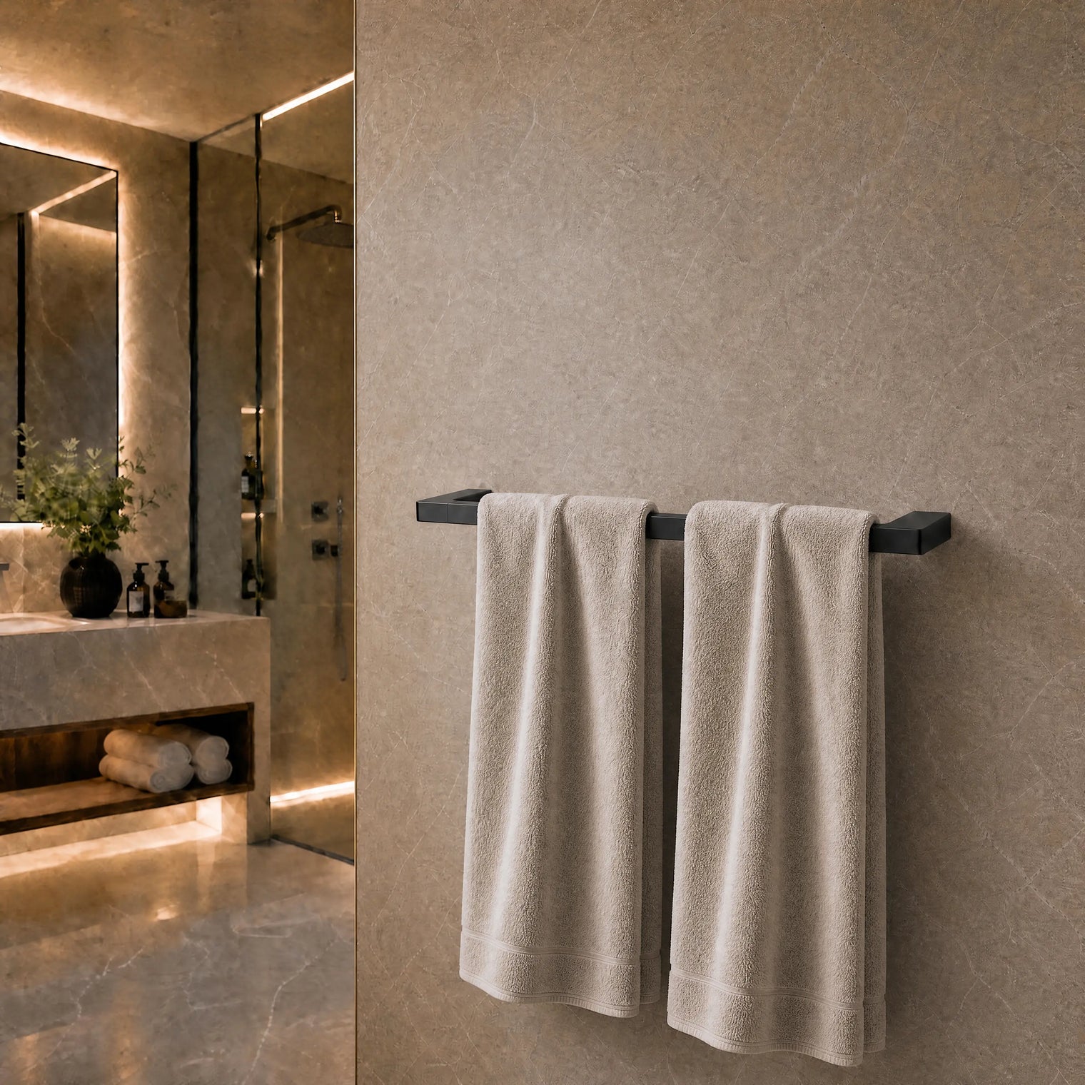 Towels hanging on a towel rack in a modern bathroom.