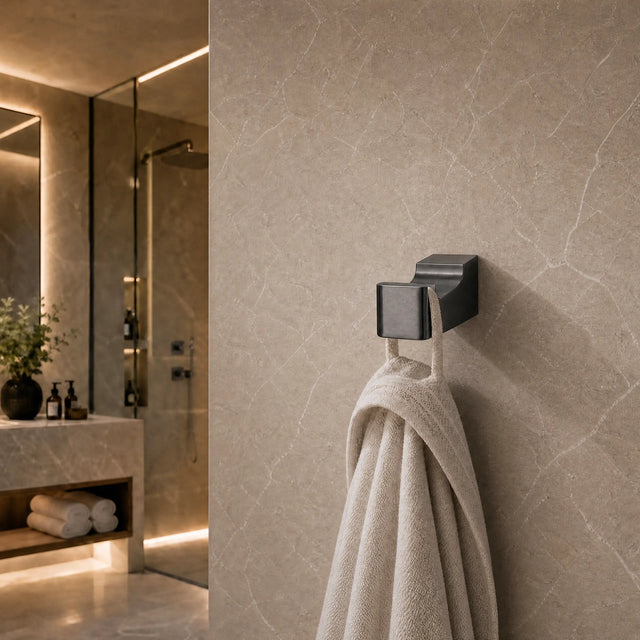 Towel hanging on a hook in a modern bathroom with neutral tones.