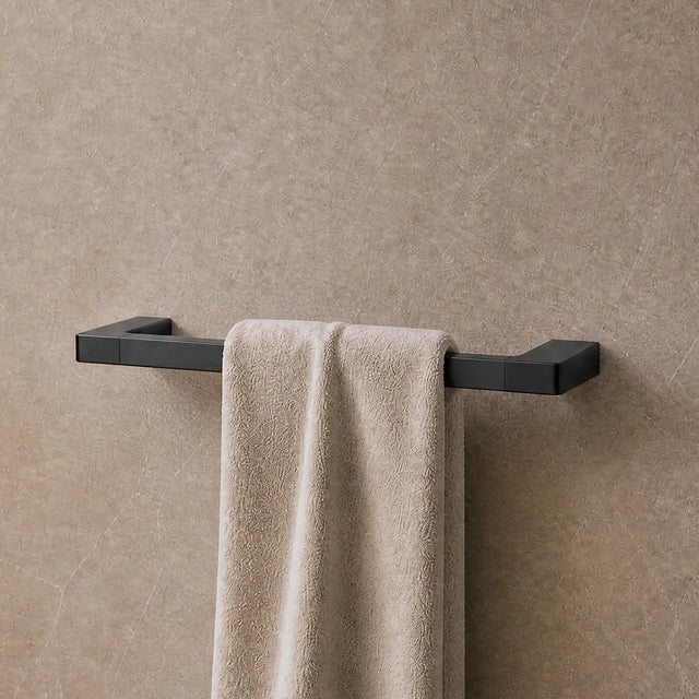 Towel hanging on a rack in a modern bathroom with neutral tones.