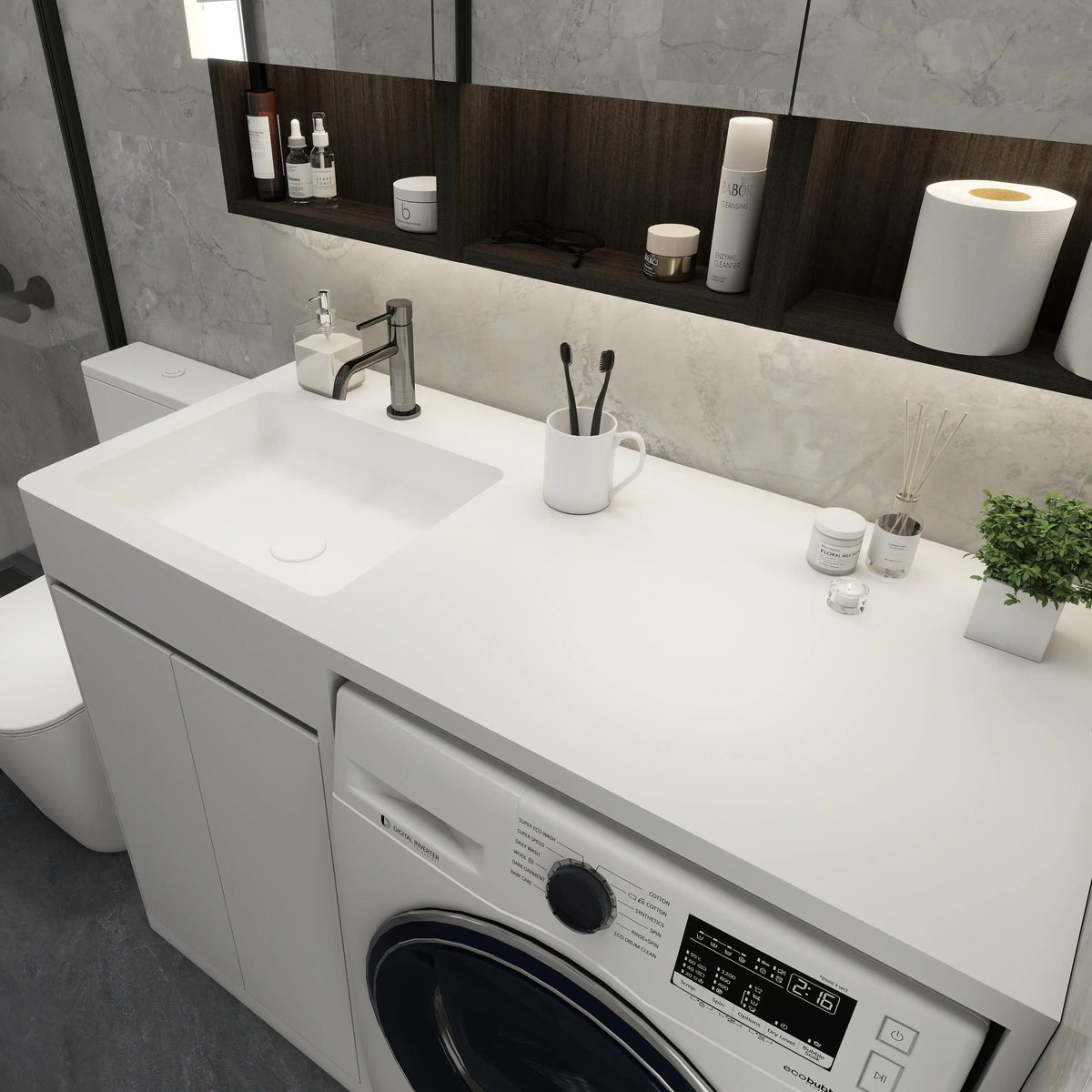 Modern bathroom with washing machine, sink, and various toiletries.