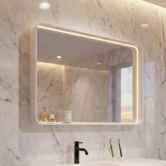 Modern bathroom with marble walls, a white vanity, and a large mirror.