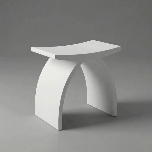 White stool with a curved design on a gray background