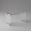 Clear acrylic side table on a gray background