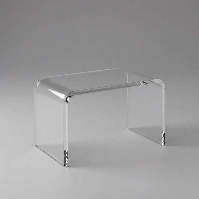 Clear acrylic side table on a gray background