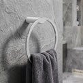 Towel rack with a towel on a stone wall in a bathroom setting