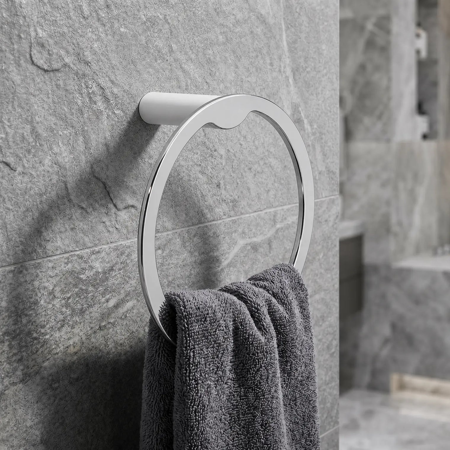 Towel rack with a towel on a stone wall in a bathroom setting