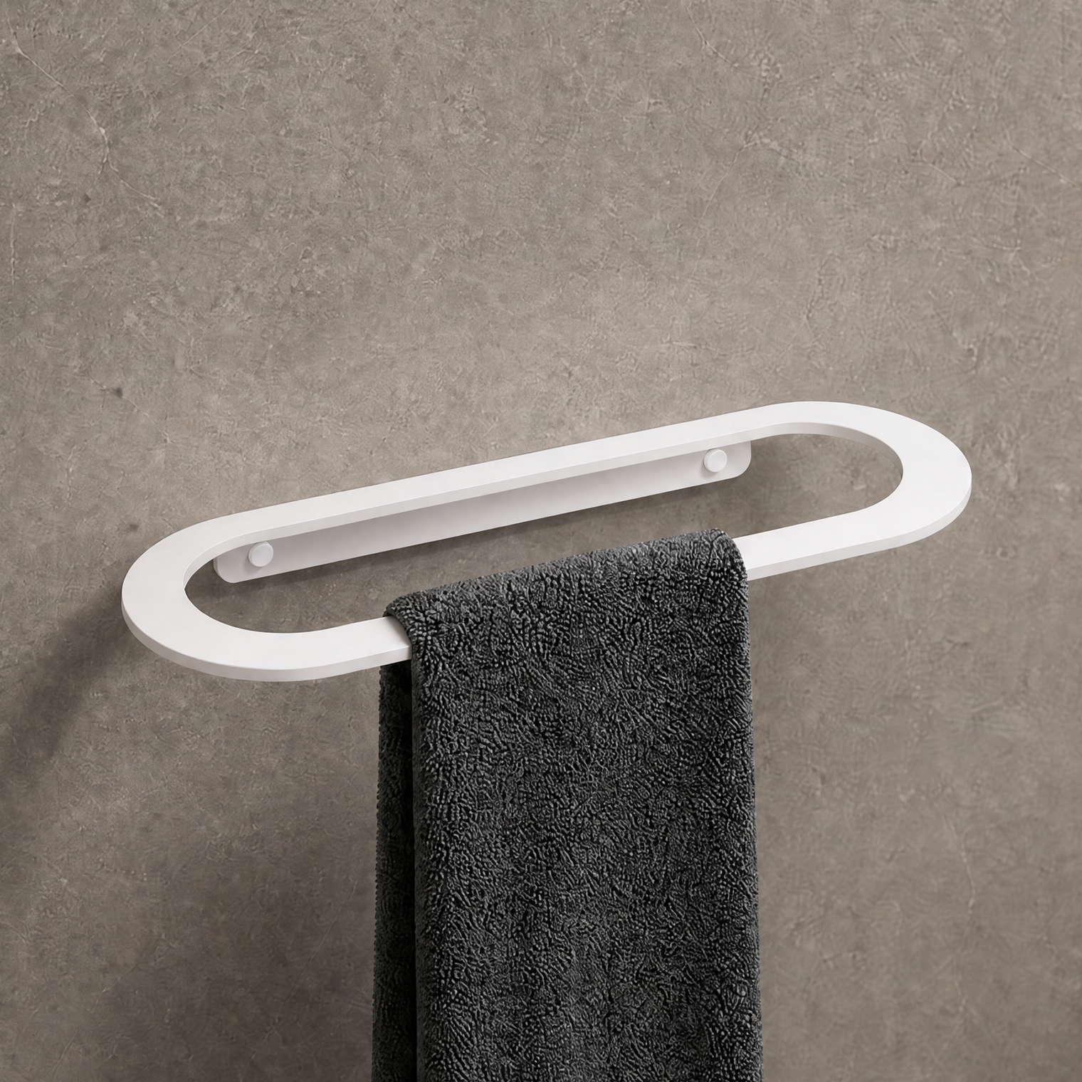 Towel rack with a black towel on a gray wall in a bathroom setting.