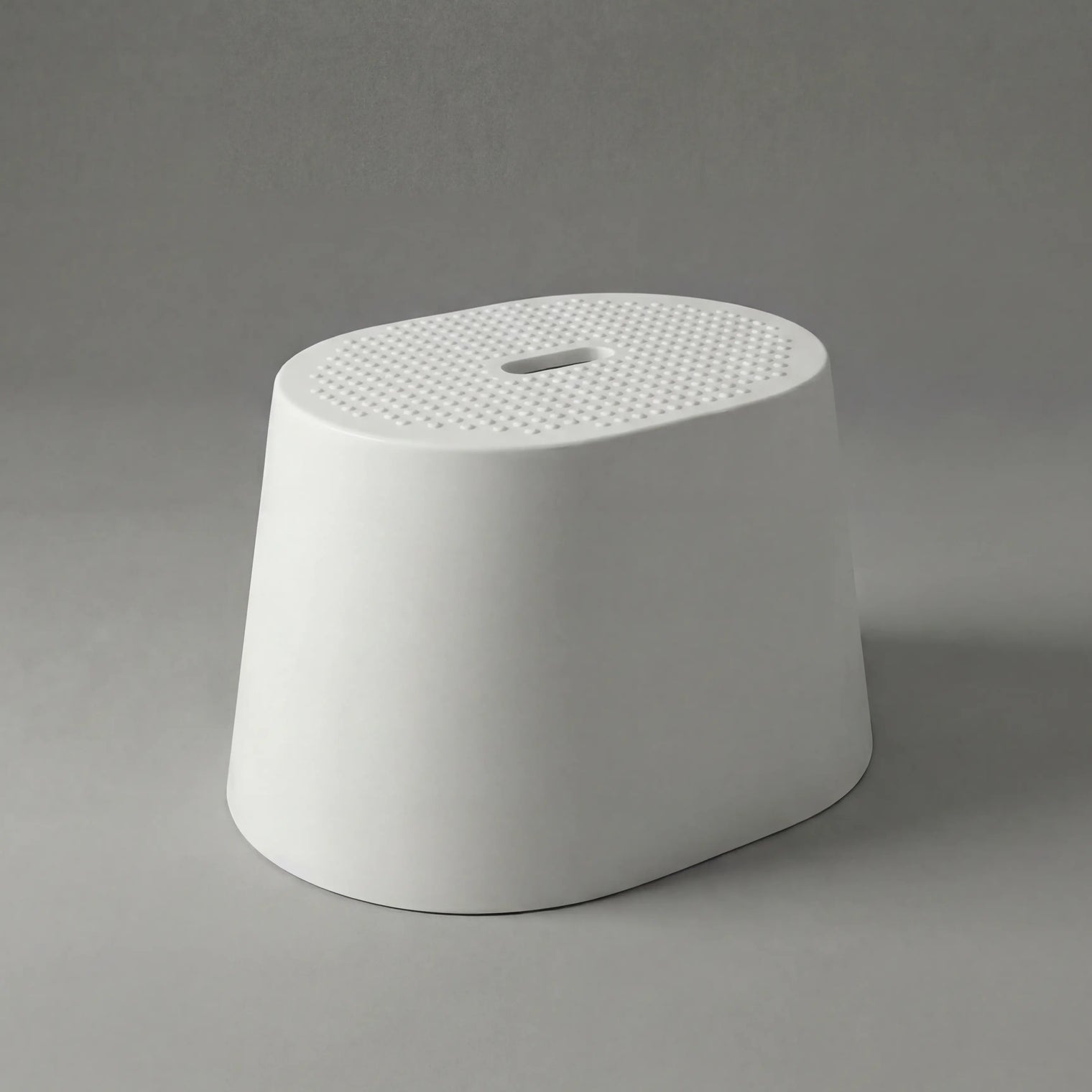 White textured stool on a gray background