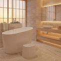 Modern bathroom with a freestanding bathtub, sink, and decorative elements.