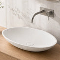 Bathroom vanity with a white sink, wooden cabinet, and decorative elements.