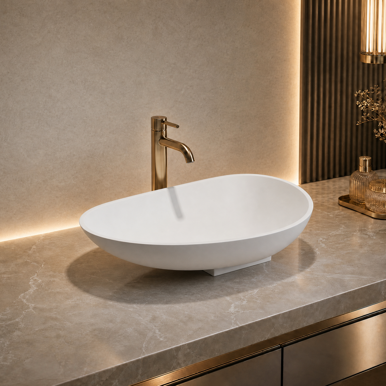 White oval Solid Surfaces sink with gold faucet on a marble countertop in a bathroom setting.