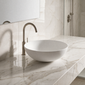 Bathroom sink with marble countertop and tiled wall