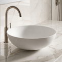 Bathroom sink with marble countertop and tiled wall