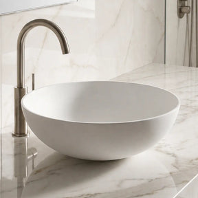 Bathroom sink with marble countertop and tiled wall
