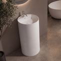 Modern bathroom with a freestanding sink and oval bathtub.