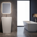 Modern bathroom with a freestanding bathtub and sink against a dark tiled wall.