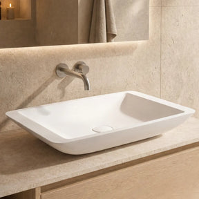 Bathroom vanity with a white sink and wooden cabinet.