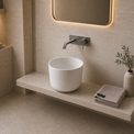 Modern bathroom with a white Solid Surfaces sink, towel, and decorative elements.