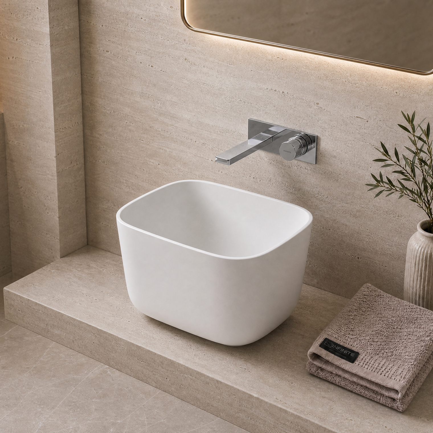 Modern bathroom with a white freestanding Solid Surfaces sink, faucet, and decorative elements.