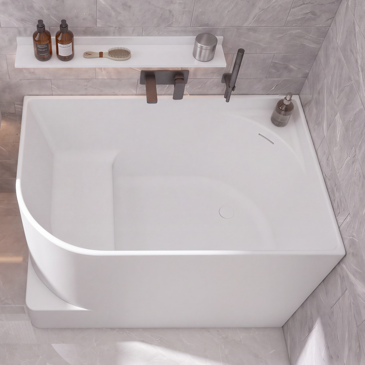 A modern bathroom scene with a large white freestanding bathtub, a white wall-mounted sink, gray stone tile walls and floor, and a few small bathroom accessories and towels.