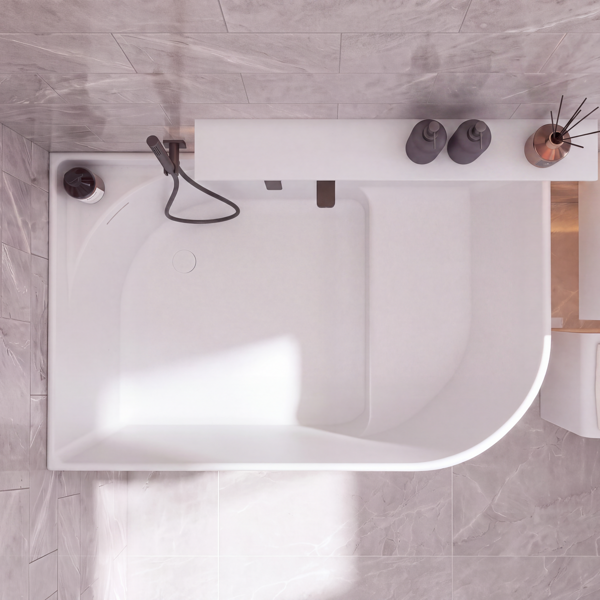 A modern white freestanding bathtub with a matte black handheld shower and faucet, shown from a top-down view in a tiled bathroom with gray stone-look tiles.