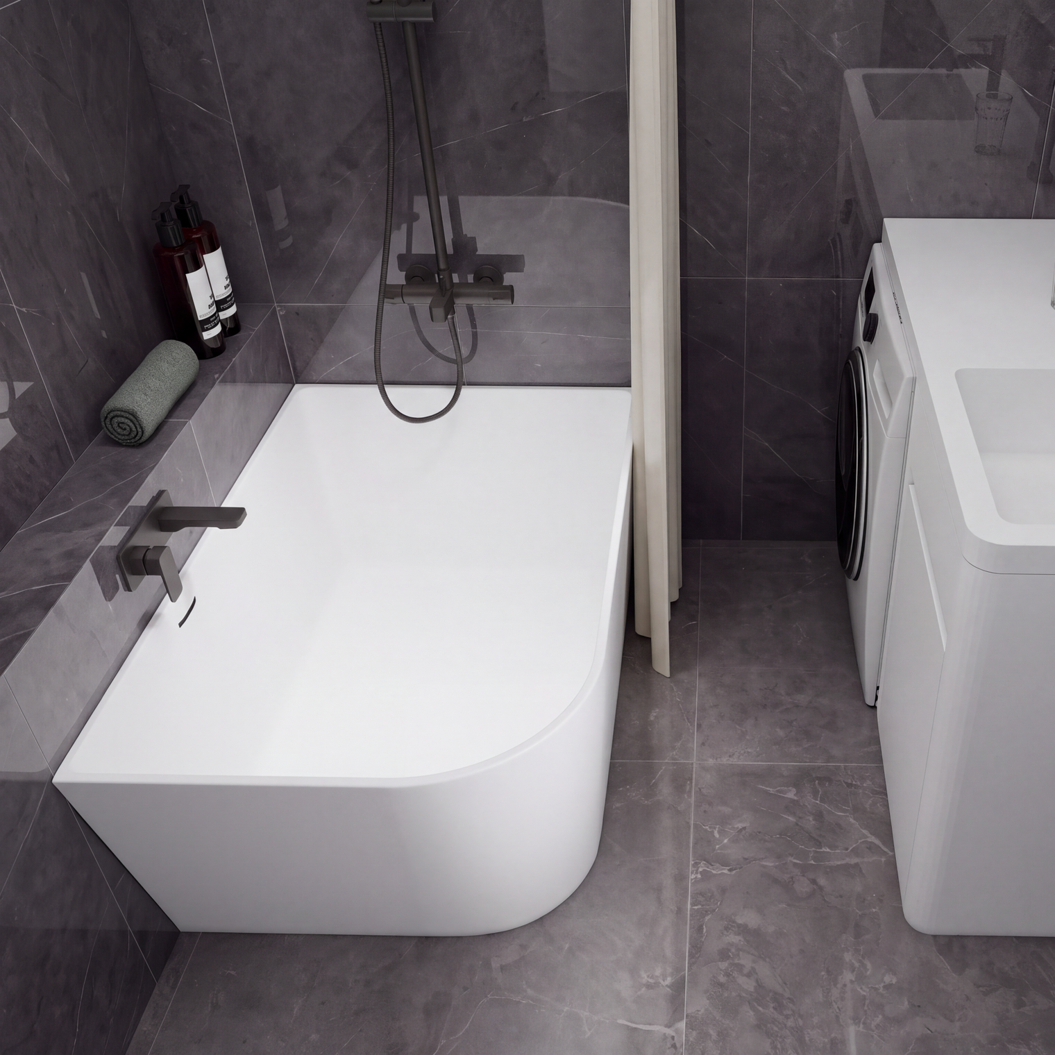 A modern bathroom setup featuring a white freestanding bathtub with a dark wall-mounted faucet and shower system, alongside a white sink vanity with a matching dark faucet and a small washing machine, all set against dark gray tiled walls and floor.