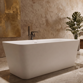 A modern freestanding white bathtub in a luxurious bathroom with textured beige stone walls, a large gold-toned abstract painting, a round wall mirror, and a wooden vanity.